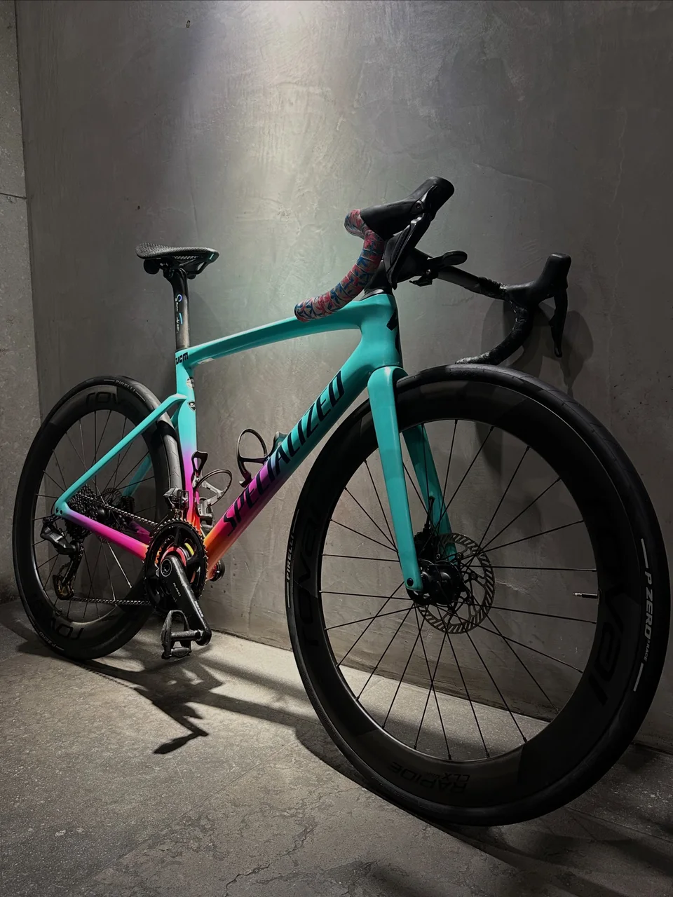 Turquoise and pink Specialized road bike photographed after workshop work
