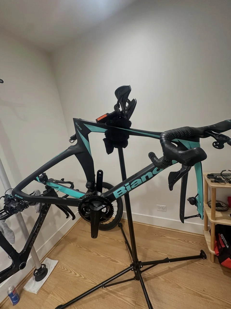 Bianchi road-bike frame held in a work stand at Velox Bike Studio